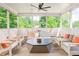 Inviting screened porch with comfortable seating, ceiling fan, and serene views of the surrounding lush greenery at 248 Madison Ave, Decatur, GA 30030