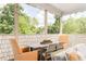 The screened porch has comfortable seating, a ceiling fan, and serene views of the surrounding lush greenery at 248 Madison Ave, Decatur, GA 30030
