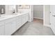 Bright bathroom featuring a double vanity, tile floors, and access to the walk-in closet at 2947 Knob Creek Dr, Snellville, GA 30078