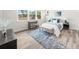 Bright bedroom featuring a light gray color palette, desk area, large rug, and a comfortable queen-size bed at 2947 Knob Creek Dr, Snellville, GA 30078