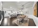 Open-concept dining room features a modern chandelier and seamless flow into the kitchen and living spaces at 2947 Knob Creek Dr, Snellville, GA 30078