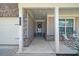 Inviting covered front porch with brick details, seating, and a view of the home's exterior at 2947 Knob Creek Dr, Snellville, GA 30078