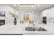 Well-lit kitchen island with white countertops, pendant lighting, and a view of the dining area and fireplace at 2947 Knob Creek Dr, Snellville, GA 30078