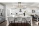Spacious kitchen island featuring white countertops, seating, and a view of the adjacent living area at 2947 Knob Creek Dr, Snellville, GA 30078