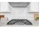 Modern kitchen features a gas stovetop with stainless steel hood and white subway tile backsplash at 2947 Knob Creek Dr, Snellville, GA 30078