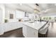 Bright kitchen featuring white cabinets, a large island with seating, and stainless steel appliances at 2947 Knob Creek Dr, Snellville, GA 30078