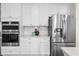 Gourmet kitchen featuring stainless steel appliances, ample white cabinetry, and modern fixtures at 2947 Knob Creek Dr, Snellville, GA 30078