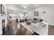 Open-concept living room with hardwood floors and a view of the modern kitchen at 2947 Knob Creek Dr, Snellville, GA 30078