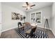 Home office featuring a ceiling fan, large window, desk, office chairs, and artwork at 2947 Knob Creek Dr, Snellville, GA 30078