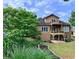 Two-story home with a wooden deck, lawn, landscaping and mature tree at 3515 Brandywine Nw Rd, Kennesaw, GA 30144