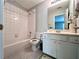 Cozy bathroom featuring a tub-shower combination with white tile and vanity with a sink at 3515 Brandywine Nw Rd, Kennesaw, GA 30144