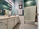Well-lit bathroom with vanity, framed prints, and shower-tub combination with white tile surround at 3515 Brandywine Nw Rd, Kennesaw, GA 30144
