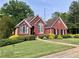 Charming brick home featuring manicured landscaping, lush green lawn, and refined architectural details at 3515 Brandywine Nw Rd, Kennesaw, GA 30144