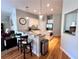 Modern kitchen featuring hardwood floors, granite countertops, an island, and a breakfast bar with stools at 3515 Brandywine Nw Rd, Kennesaw, GA 30144