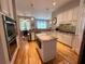 Open kitchen with hardwood floors, granite countertops, island with microwave, and stainless steel appliances at 3515 Brandywine Nw Rd, Kennesaw, GA 30144