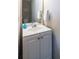 Small bathroom with single sink vanity and a decorative wall mirror at 883 Heritage Pl, Decatur, GA 30033