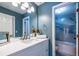 Stylish bathroom with blue walls, white vanity, and a shower/tub combo with decorative tile at 883 Heritage Pl, Decatur, GA 30033