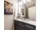 Modern bathroom with dark wood vanity, white countertop, framed mirror, and decorative artwork at 883 Heritage Pl, Decatur, GA 30033