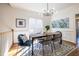 Modern dining room featuring stylish lighting fixture, statement artwork, and a patterned rug at 883 Heritage Pl, Decatur, GA 30033