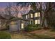 Charming gray home with lush landscaping, a two-car garage, and a unique turret-style architectural detail at 883 Heritage Pl, Decatur, GA 30033