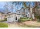 Stunning two-story home showcasing a light gray stucco exterior, well manicured shrubs and a two car garage at 883 Heritage Pl, Decatur, GA 30033