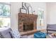Living room brick fireplace with modern decor, large windows, and comfortable seating at 883 Heritage Pl, Decatur, GA 30033
