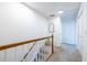 Upstairs hallway with carpet floors, white walls, and wood railing at 883 Heritage Pl, Decatur, GA 30033