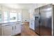 Open kitchen showcasing stainless steel refrigerator, breakfast bar, and hardwood floors creating a functional space at 883 Heritage Pl, Decatur, GA 30033