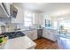 Modern kitchen featuring white cabinets, stainless steel appliances, and a breakfast nook in the background at 883 Heritage Pl, Decatur, GA 30033