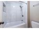 Bathroom featuring a tub with white tile surround and a handheld shower at 883 Heritage Pl, Decatur, GA 30033
