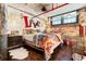 Bright bedroom boasts exposed brick, wood floors and beams, and LOVE decor at 170 Boulevard Se # E003, Atlanta, GA 30312