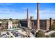 This exterior shot showcases a historic building, with two large smoke stacks, and full parking area at 170 Boulevard Se # E003, Atlanta, GA 30312