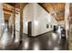Long hallway with exposed beams, brick columns, and hard wood floors at 170 Boulevard Se # E003, Atlanta, GA 30312