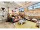 Bright living area features exposed brick, hard wood floors, modern lighting, and eclectic furniture at 170 Boulevard Se # E003, Atlanta, GA 30312