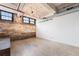 Spacious living area with exposed brick wall, high ceilings, and industrial-chic design elements at 170 Boulevard Se # E003, Atlanta, GA 30312