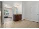 Bright bathroom with a modern vanity, neutral tile flooring, and an adjoining bedroom with wood-look flooring at 218 3Rd Ave, Avondale Estates, GA 30002