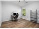 Bright bedroom showcasing wood-look flooring, a large window, and ample space for a productive work-from-home setup at 218 3Rd Ave, Avondale Estates, GA 30002