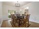 Elegant dining room with wainscoting, designer light fixture, and large window overlooking the yard at 218 3Rd Ave, Avondale Estates, GA 30002
