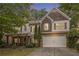 Charming two-story home with brick and shingle accents, well-maintained landscaping and inviting covered front porch at 218 3Rd Ave, Avondale Estates, GA 30002
