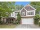 Charming two-story home with brick and shingle accents, well-maintained landscaping and inviting covered front porch at 218 3Rd Ave, Avondale Estates, GA 30002