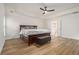 Spacious primary bedroom featuring hardwood floors, a tray ceiling, and an en suite bathroom with soaking tub at 218 3Rd Ave, Avondale Estates, GA 30002