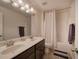 Bright bathroom featuring a tub/shower and double vanity with solid surface counters at 544 Pine Way, Dallas, GA 30157