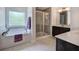 Bathroom featuring a soaking tub, a shower, and a double sink vanity at 544 Pine Way, Dallas, GA 30157