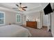 Relaxing bedroom has a trey ceiling, wall-mounted tv, ceiling fan, and carpet at 544 Pine Way, Dallas, GA 30157