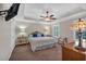 Comfortable bedroom featuring a trey ceiling, carpet, ceiling fan and a television for a relaxing atmosphere at 544 Pine Way, Dallas, GA 30157