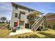 Back of house with wooden stairs leading to an upper covered patio at 544 Pine Way, Dallas, GA 30157