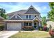 Charming two-story home with a stone-accented garage, beautiful landscaping, and inviting front porch at 544 Pine Way, Dallas, GA 30157