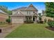 Charming two-story home with stone-accented garage, landscaped front yard and a welcoming entryway at 544 Pine Way, Dallas, GA 30157