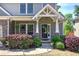 Inviting front porch with decorative columns and blooming flowers enhancing curb appeal at 544 Pine Way, Dallas, GA 30157