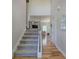 Hallway featuring hardwood floors leading to a staircase and glimpses of the living area at 544 Pine Way, Dallas, GA 30157
